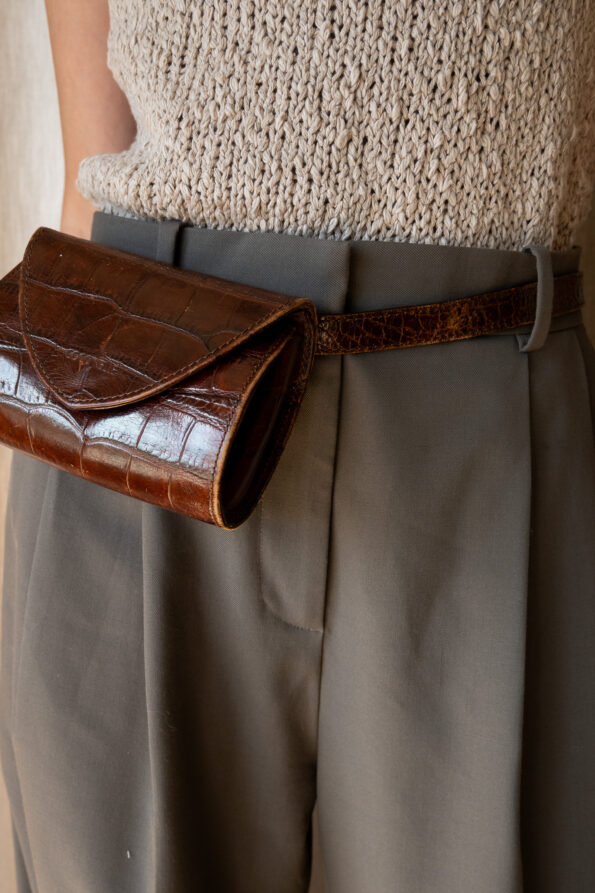 The embossed brown leather bum bag
